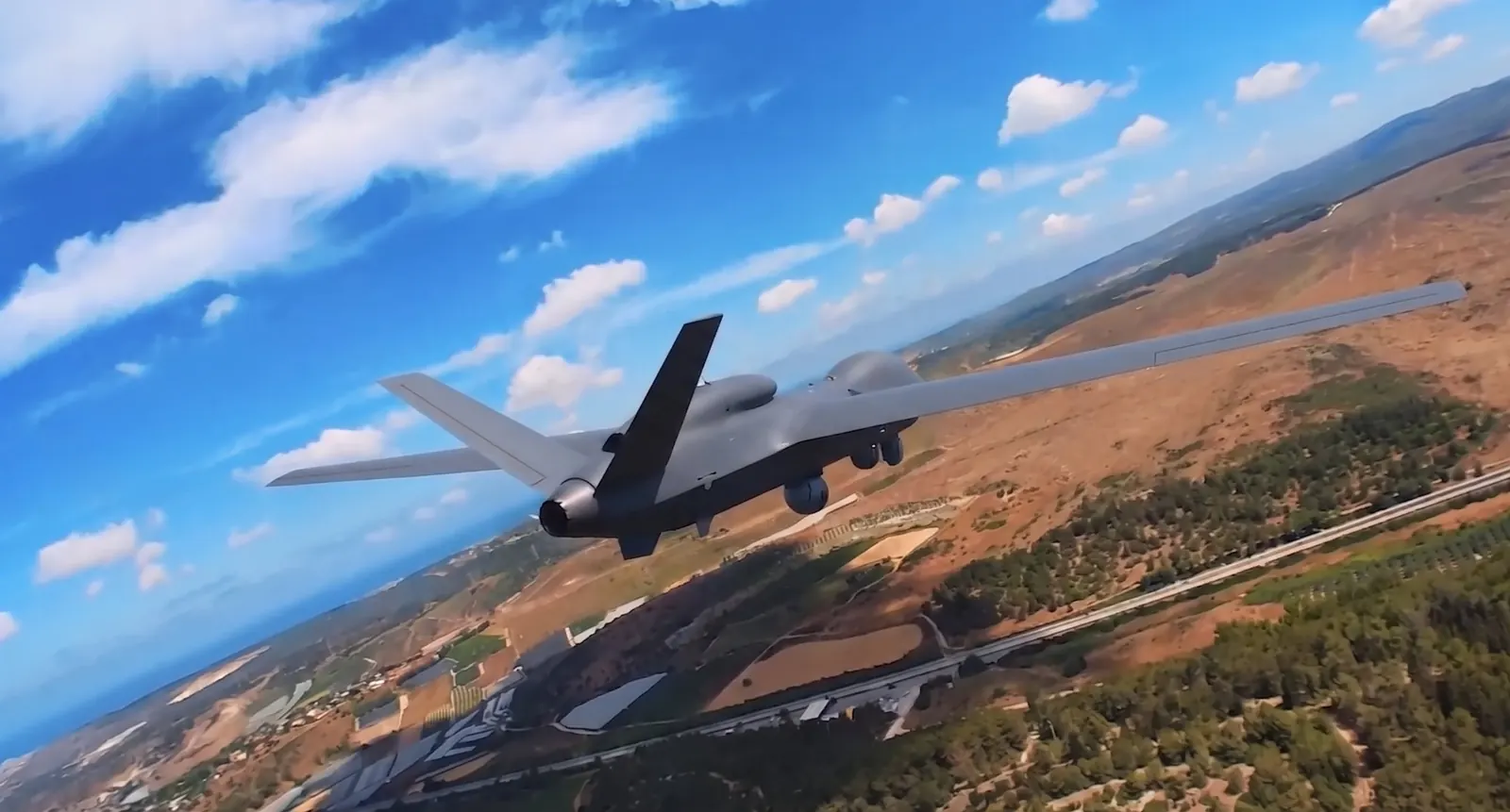 An unmanned aircraft in flight over open country